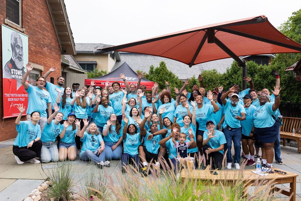 The full foundation team and volunteers waving in a big group photo