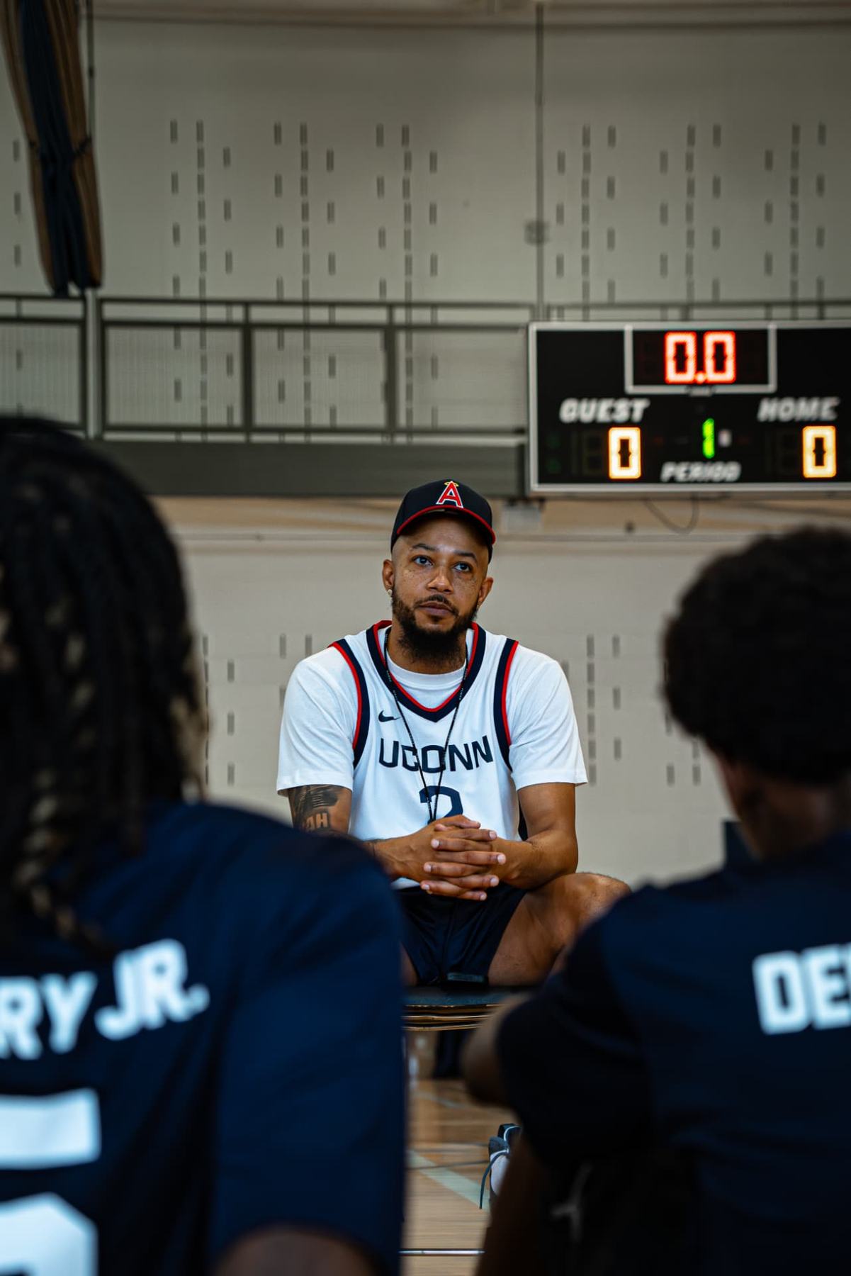 A guest speaker sits with campers during a mentorship session at the Raleigh camp.
