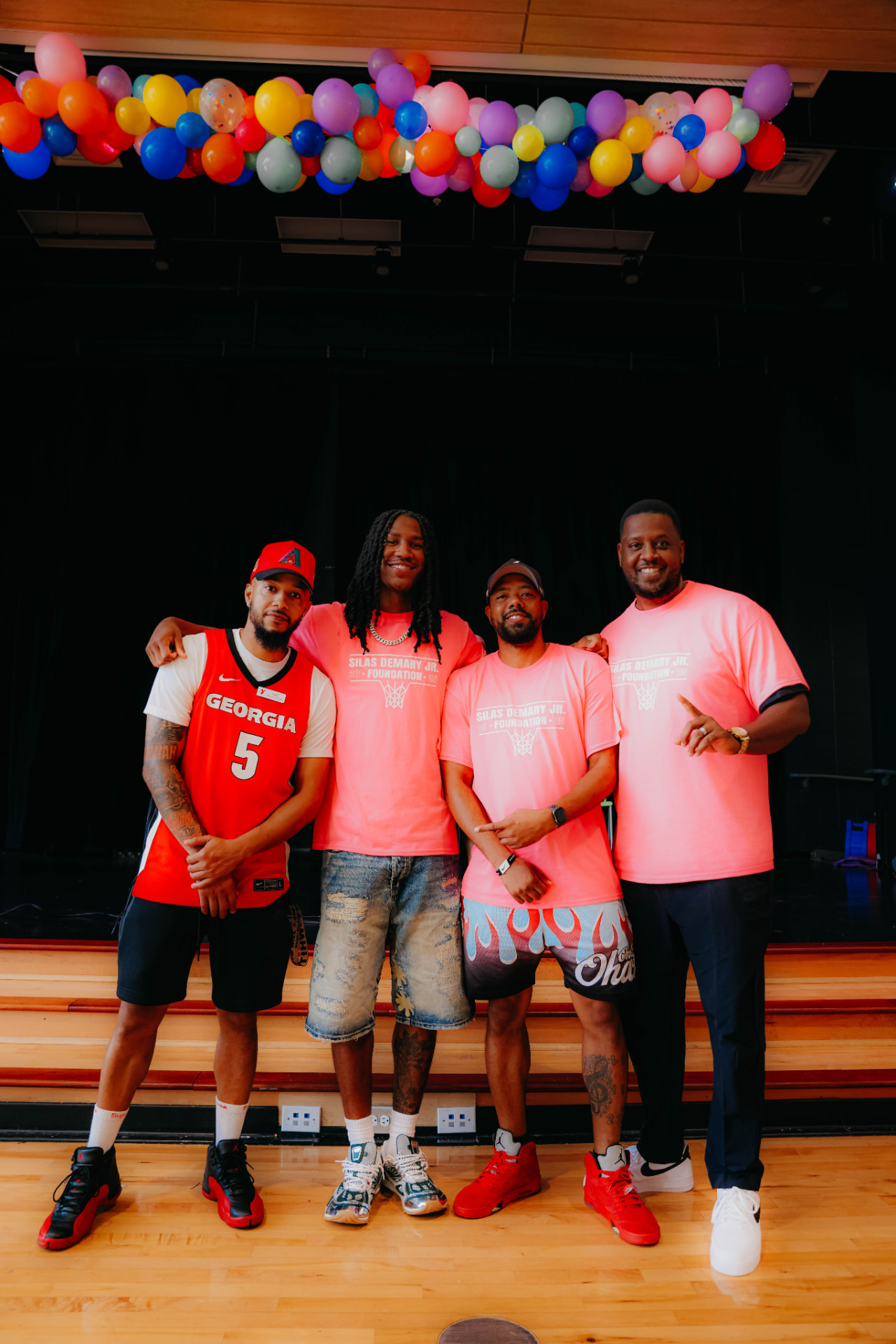 Silas Demary Jr. poses with three supporters, including one in a Georgia jersey, at the 2025 Back to School Bash.