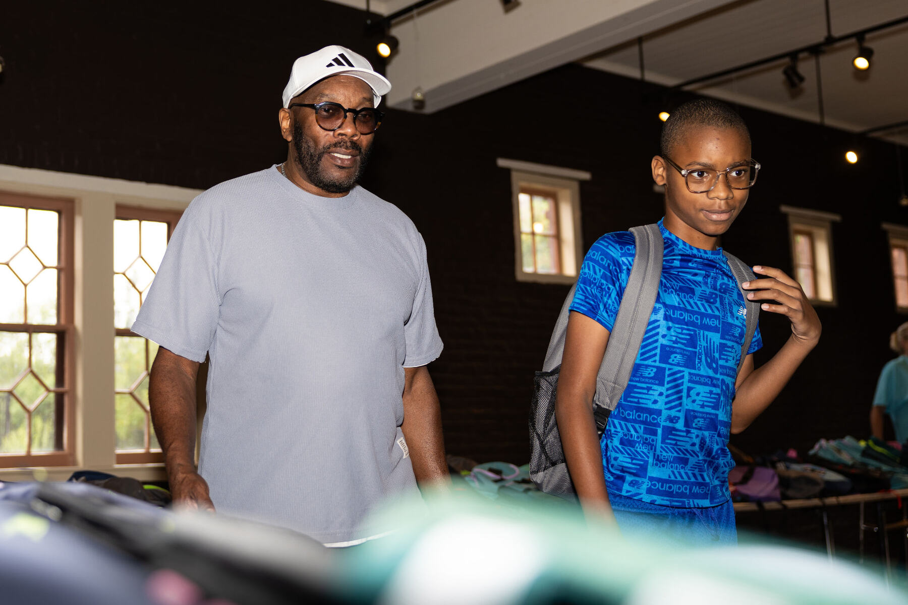 Silas Demary Sr. with a young guest inside the supply room