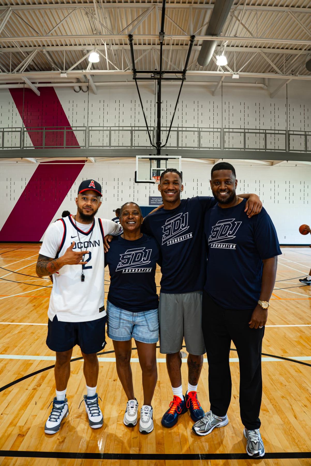 Silas Demary Jr. and family pose together on the court at the 2026 Raleigh basketball camp.