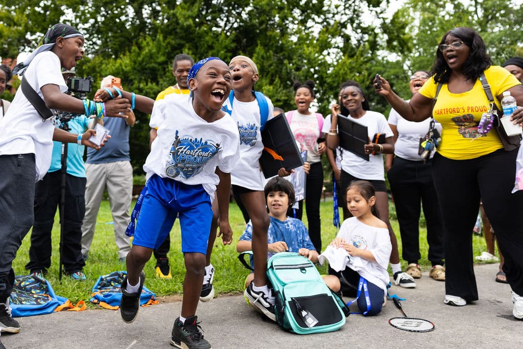 Kids celebrating during games on the green at the Hartford bash