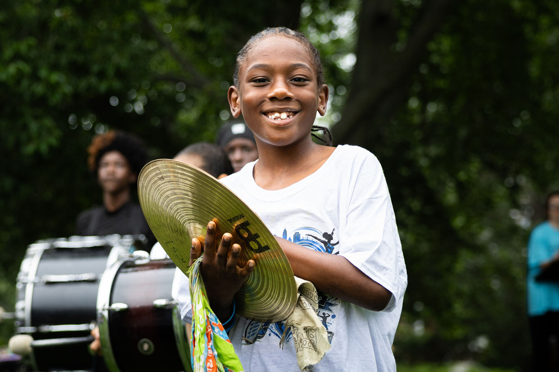 A young musician holding a cymbal during the drumline performance