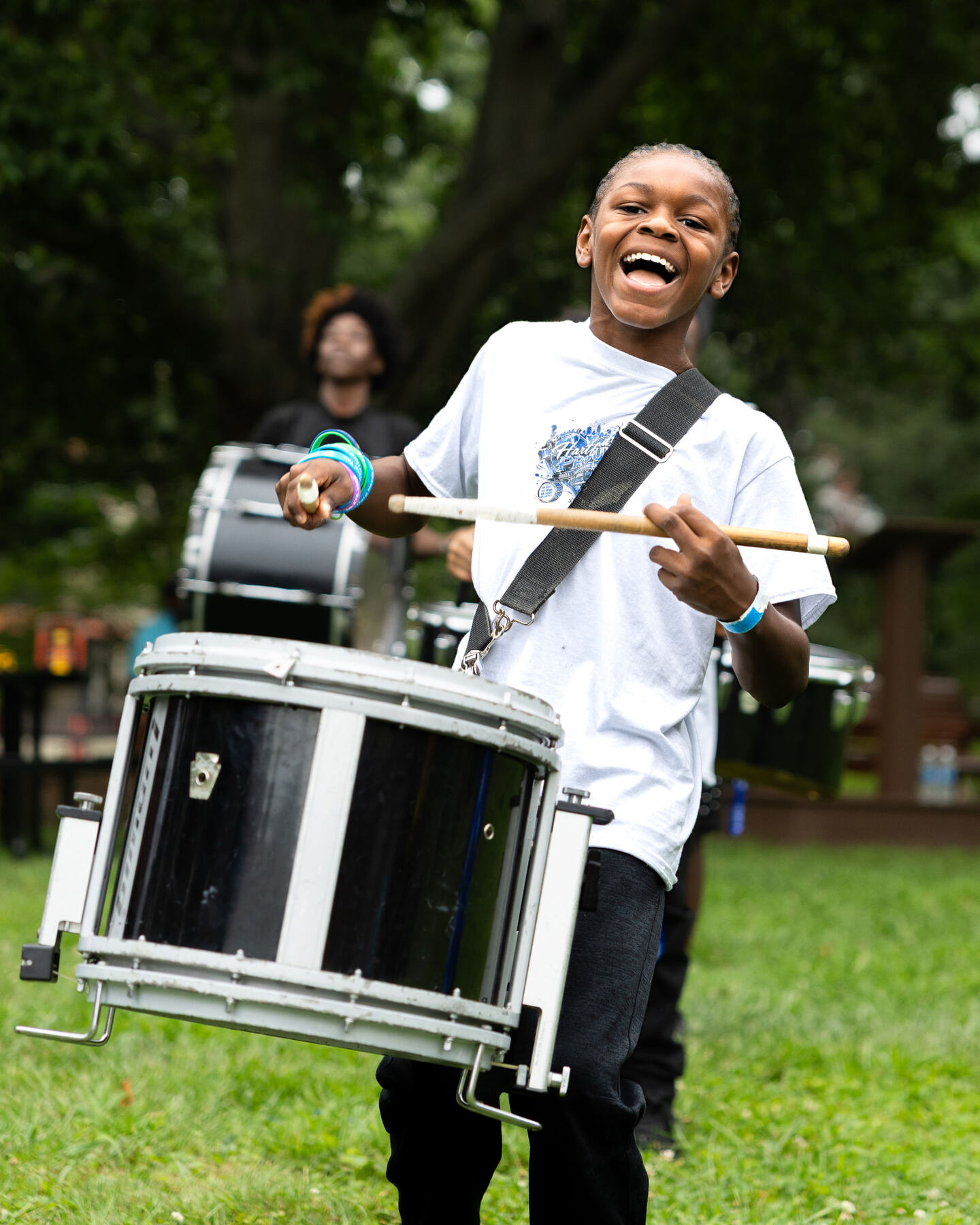 A young drummer smiling during the Hartford drumline performance