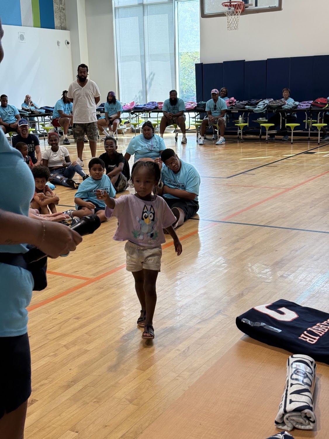 A young girl walks across the gym floor during an activity at the 2026 Raleigh Back to School Bash.