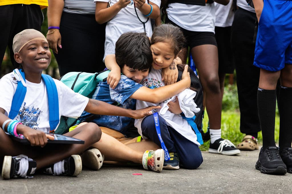 Kids hugging while sitting together at the event