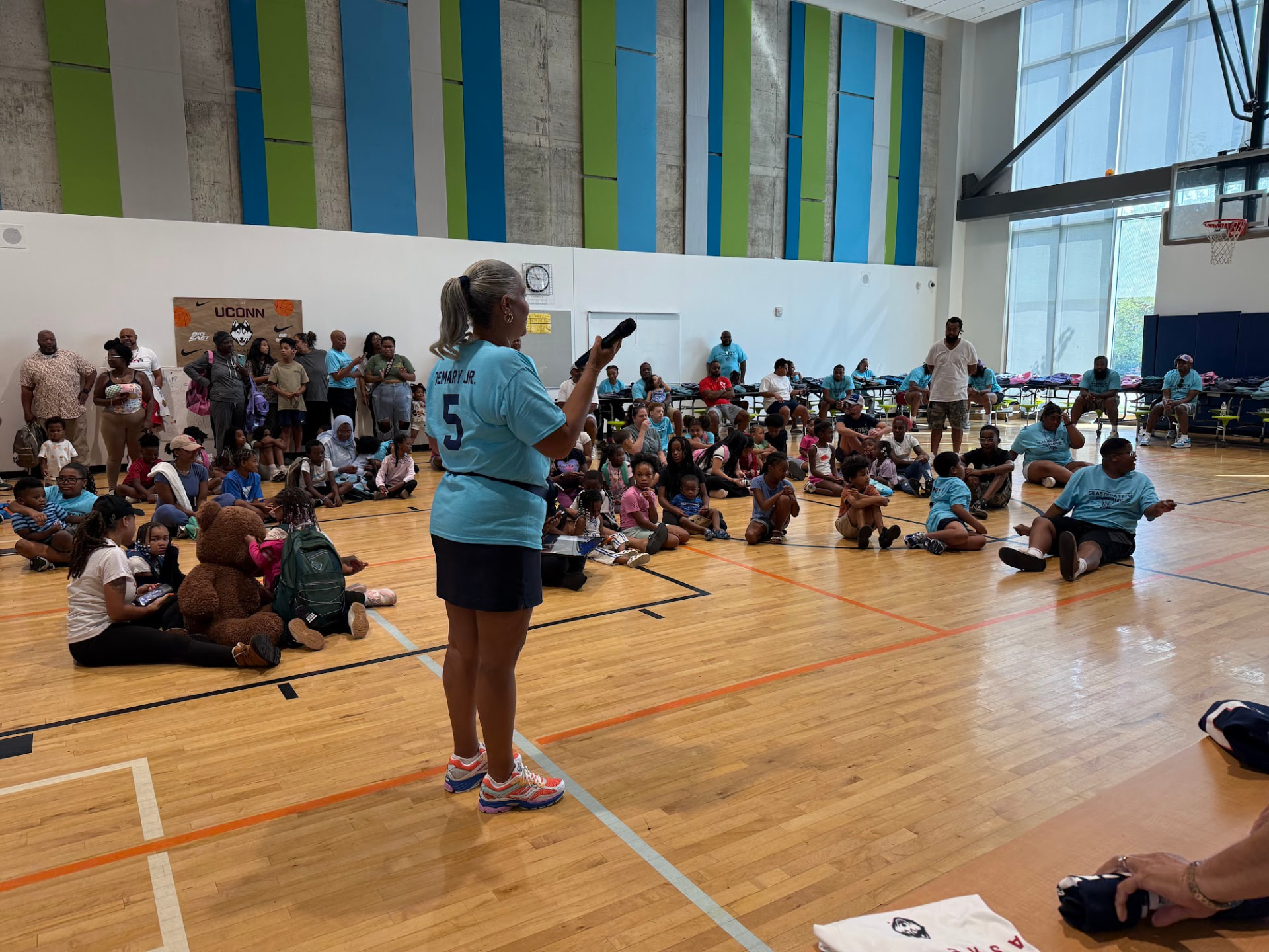 Shanté Demary speaks to a gymnasium full of families and children at the 2026 Raleigh Back to School Bash.
