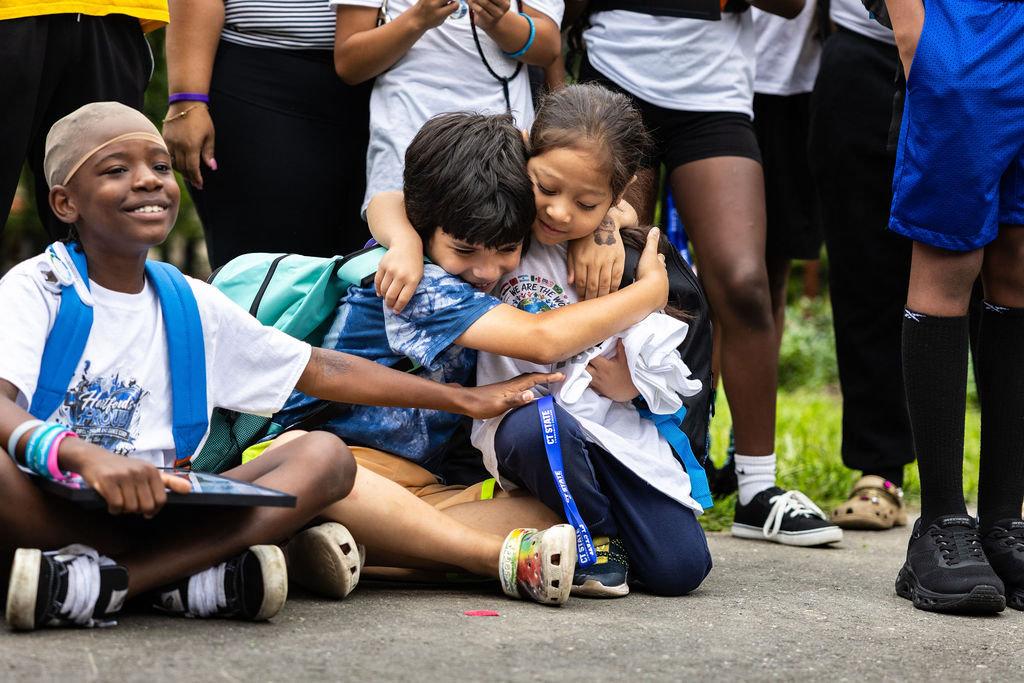 Children hugging at a back-to-school event