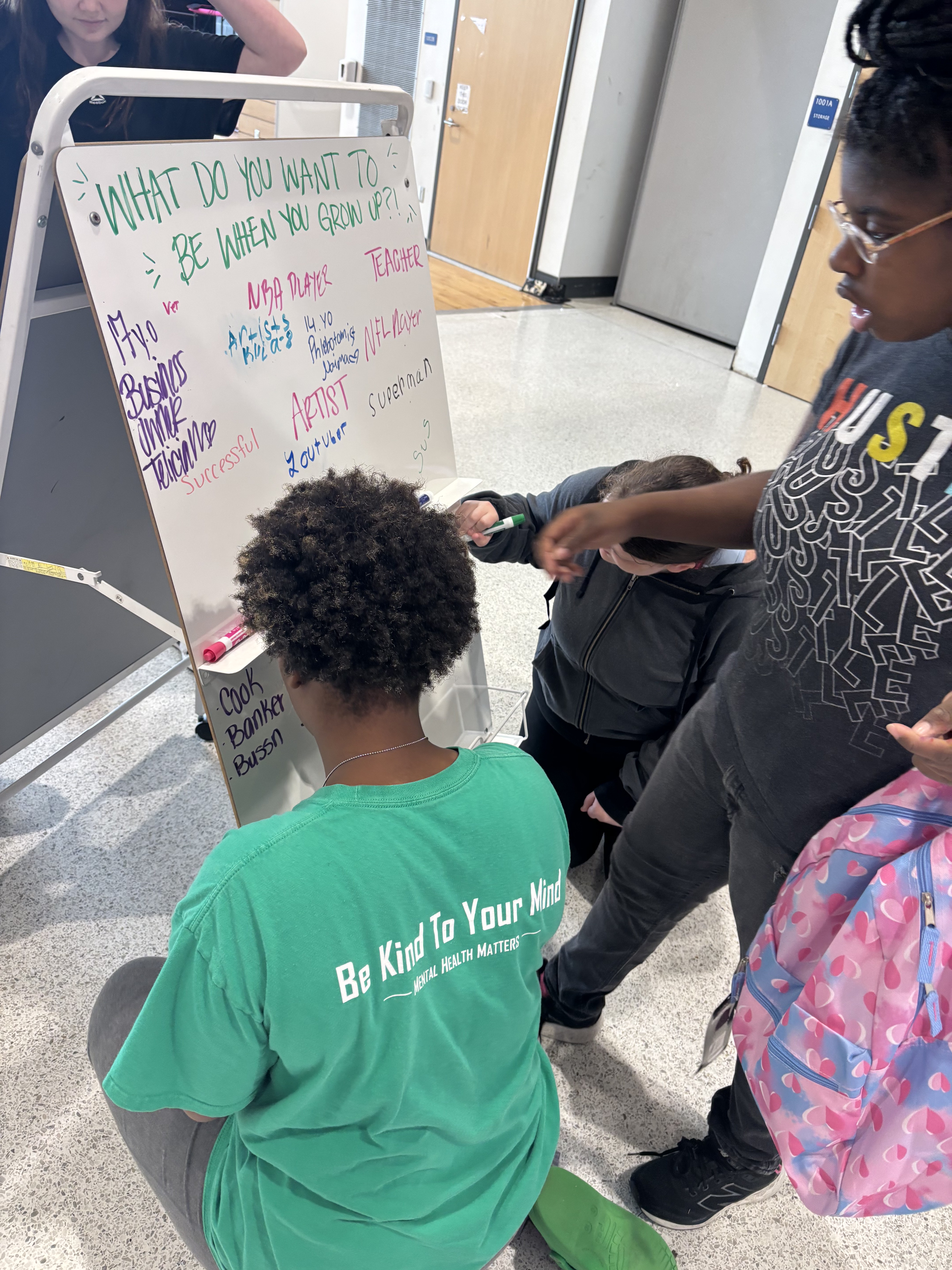 A whiteboard filled with students' answers to "What do you want to be when you grow up?" at the 2025 Back to School Bash.