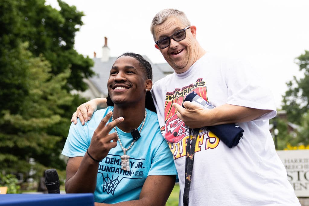 Silas Demary Jr. posing with a community member at the bash