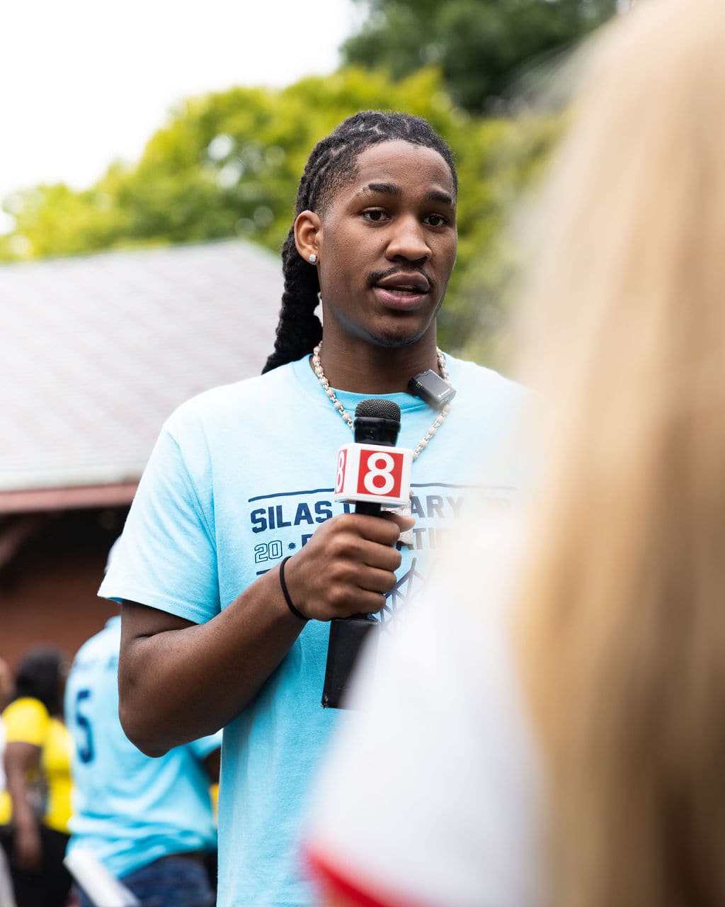 Silas Demary Jr. speaking into a Channel 8 microphone