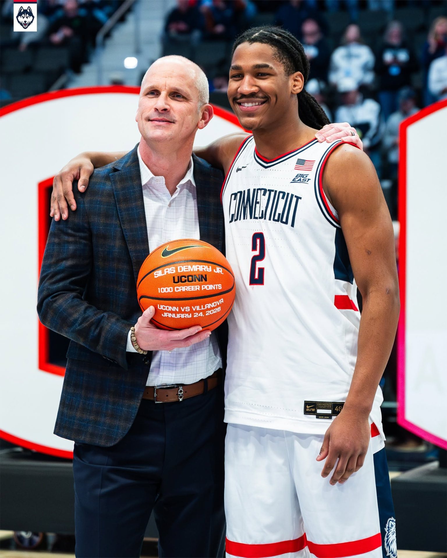 Silas Demary Jr. stands with UConn head coach Dan Hurley after reaching 1,000 career points.