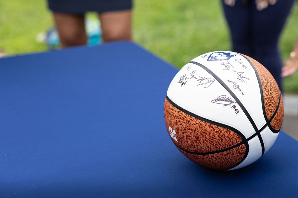 A basketball covered in team autographs at the Hartford bash