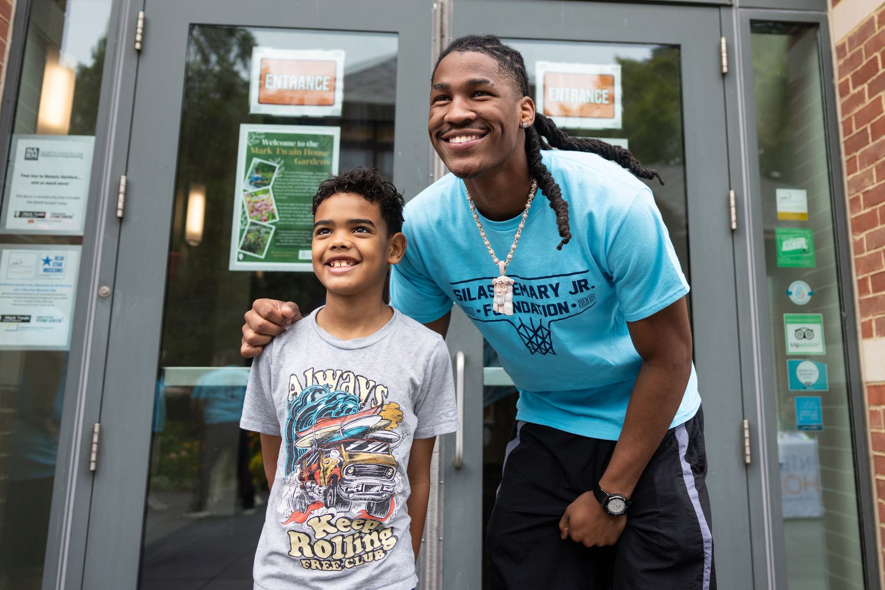 Silas Demary Jr. greeting a young fan at the entrance
