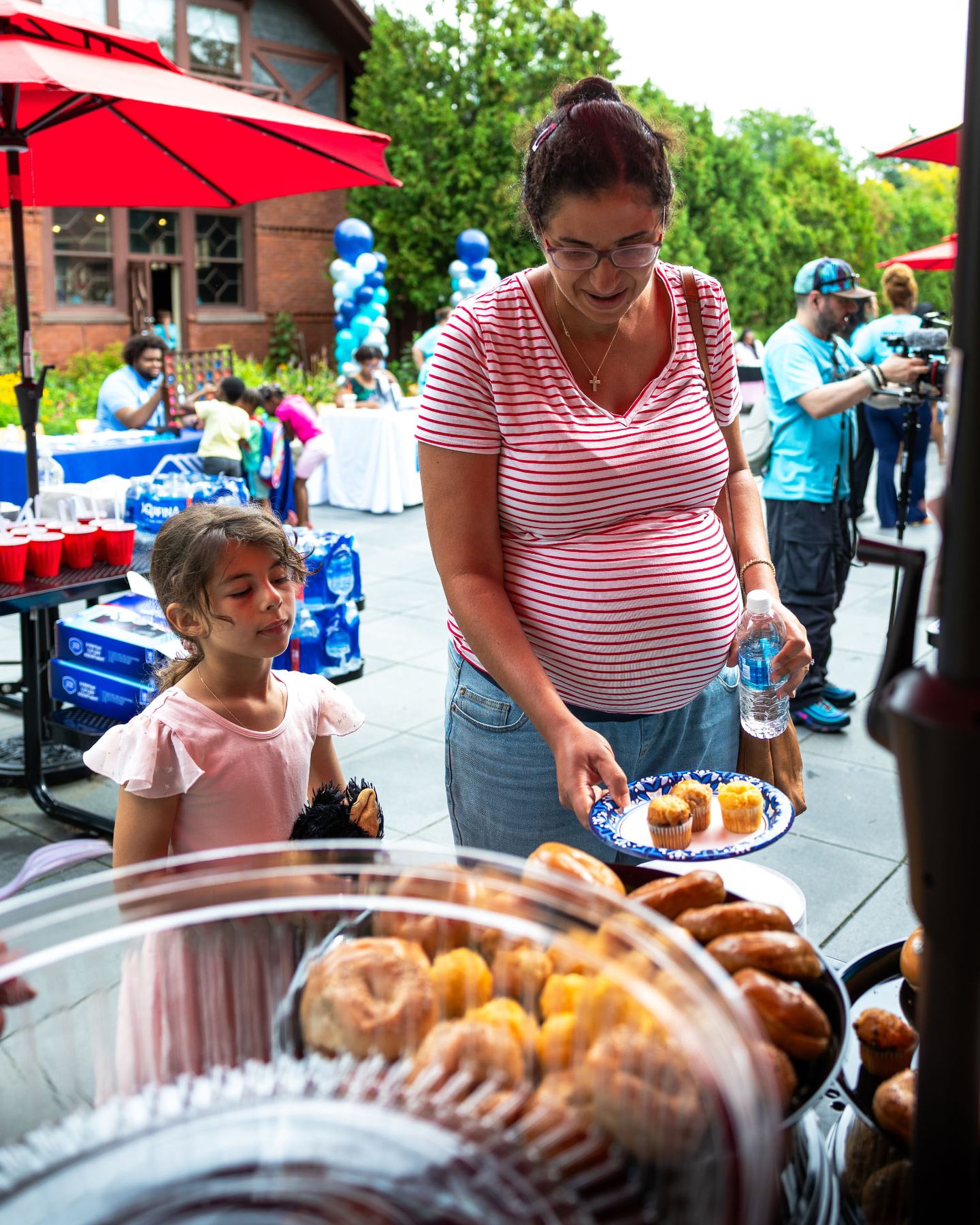 A mother and daughter picking out breakfast treats