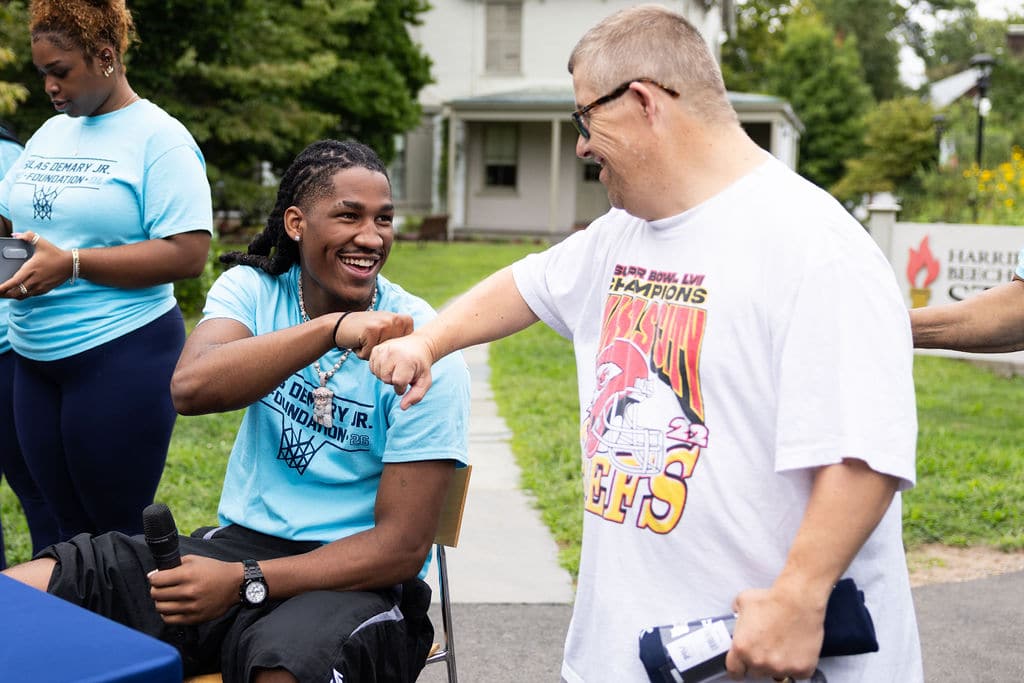 Silas Demary Jr. sharing a fist bump with a community member