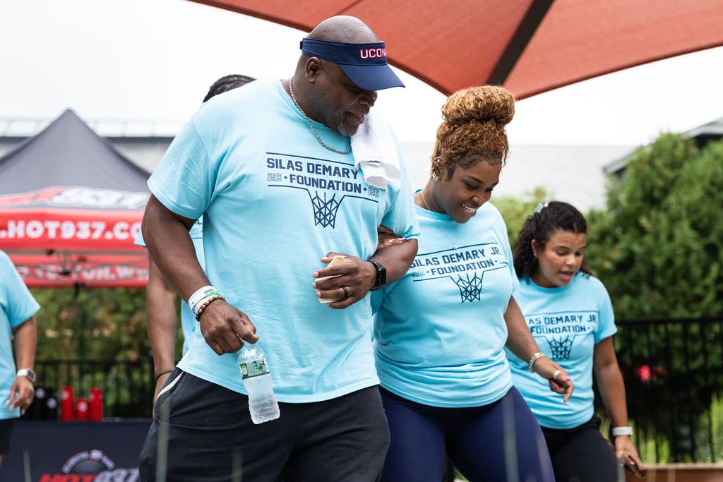 Foundation family members walking arm in arm at the bash