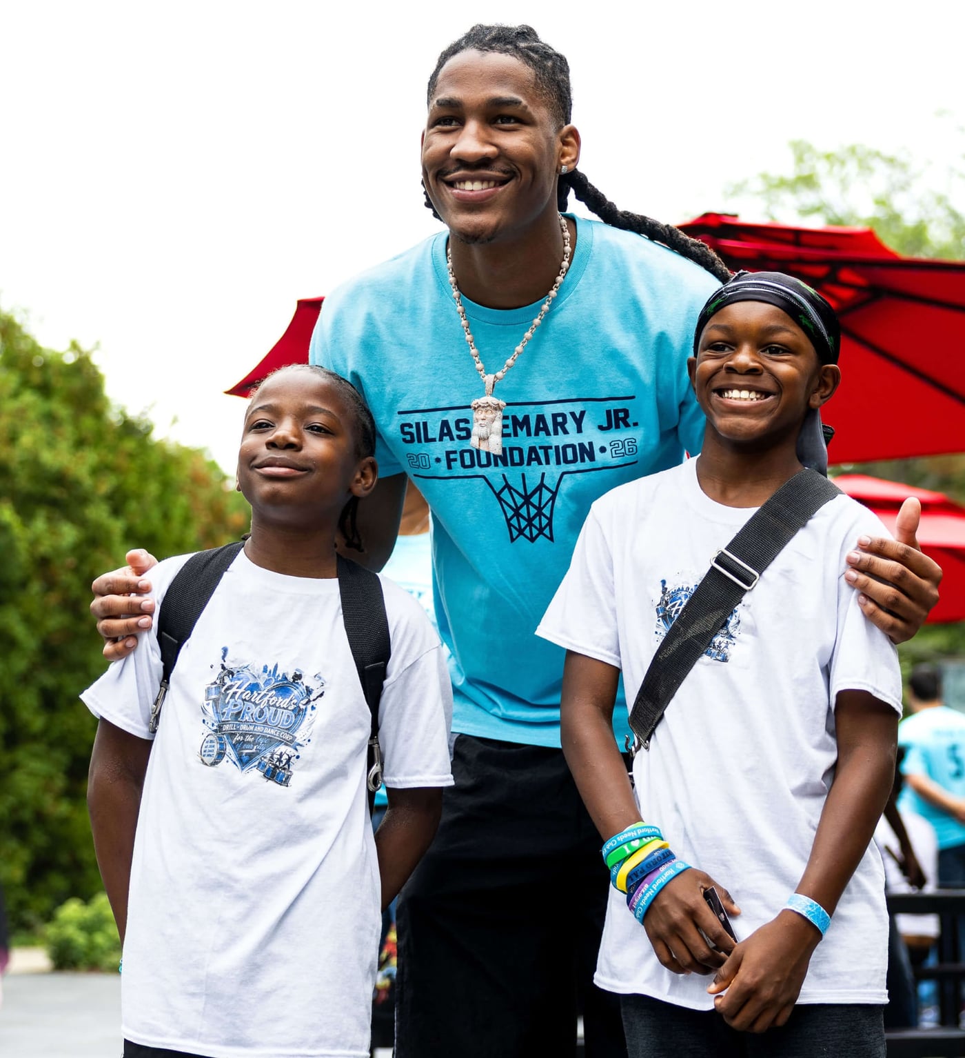 Silas Demary Jr. with two young fans at the Hartford Back to School Bash