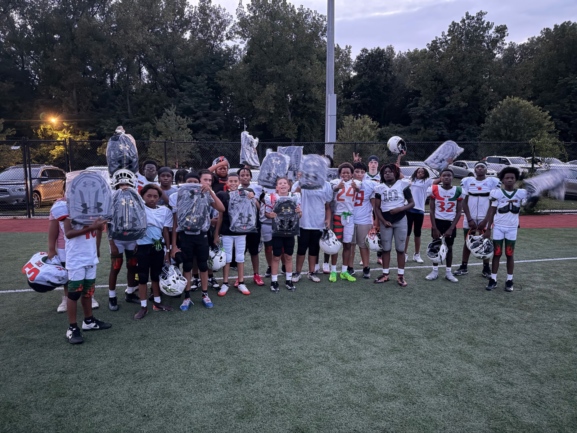 The Hartford Hurricanes 12U football team poses on the field with new backpacks and gear provided by the foundation.