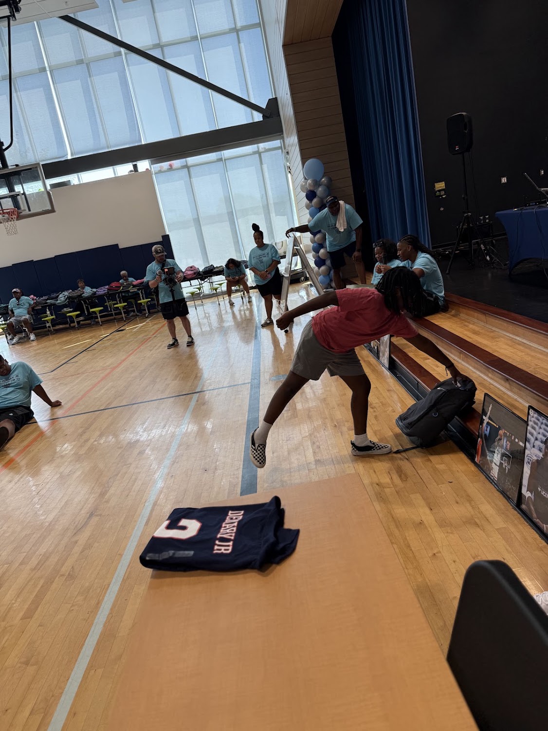 A child reaches for a backpack during the 2026 Raleigh Back to School Bash.