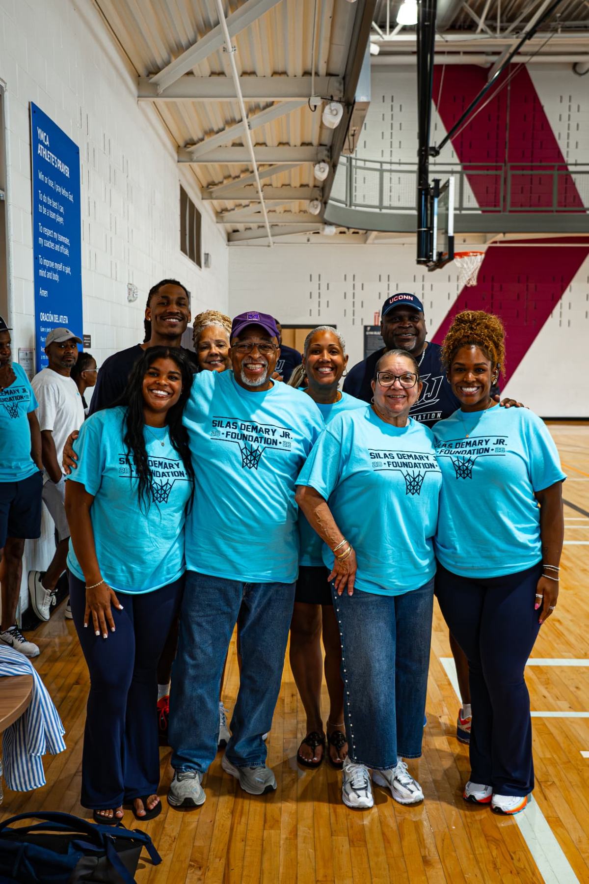Foundation volunteers smile together at the 2026 Raleigh basketball camp.