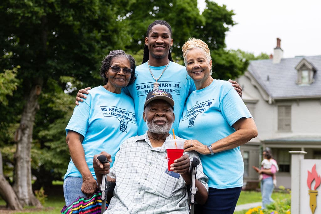 Silas Demary Jr. with family members around his grandfather