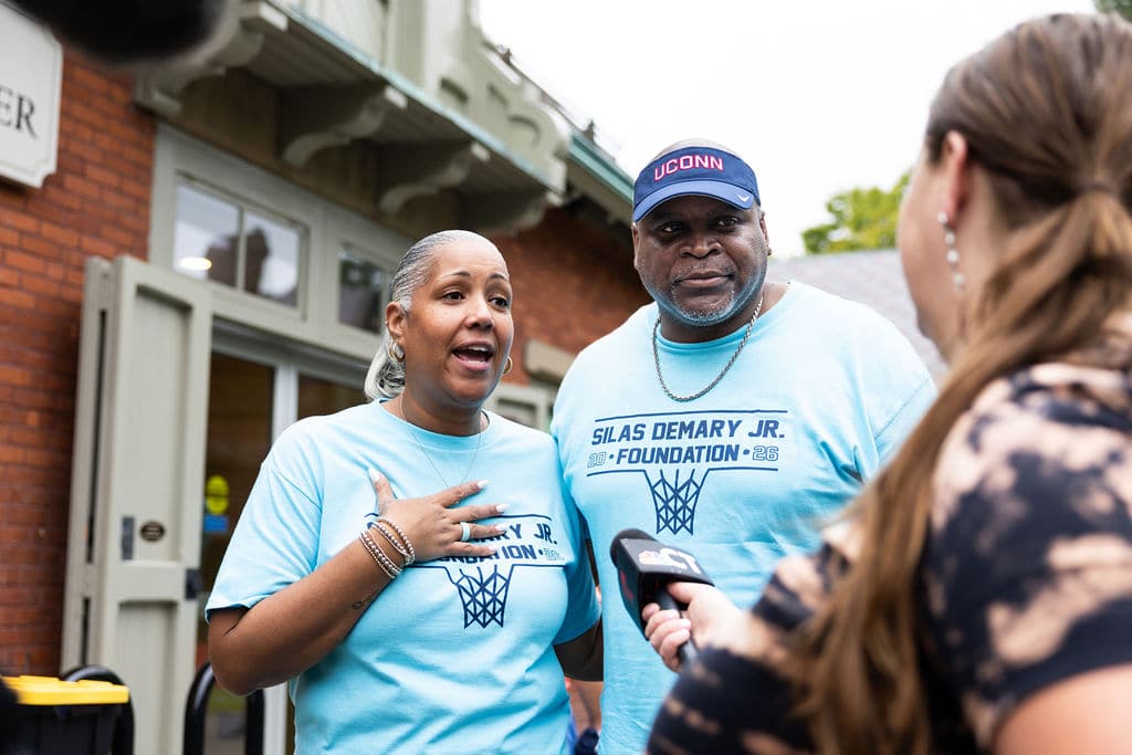 Silas's parents speaking with a reporter at the bash